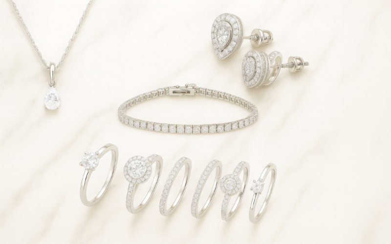 Silver jewelry set including necklace, bracelet, and earrings on a light background